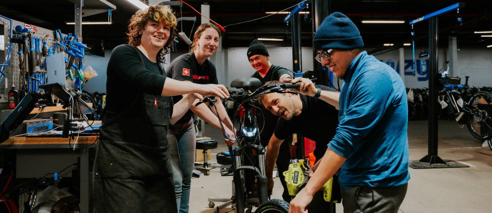 Upway team of mechanics working on an electric bike