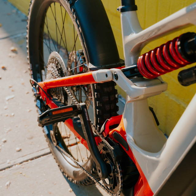 a red and white Cannondale Moterra full suspension electric mountain bike