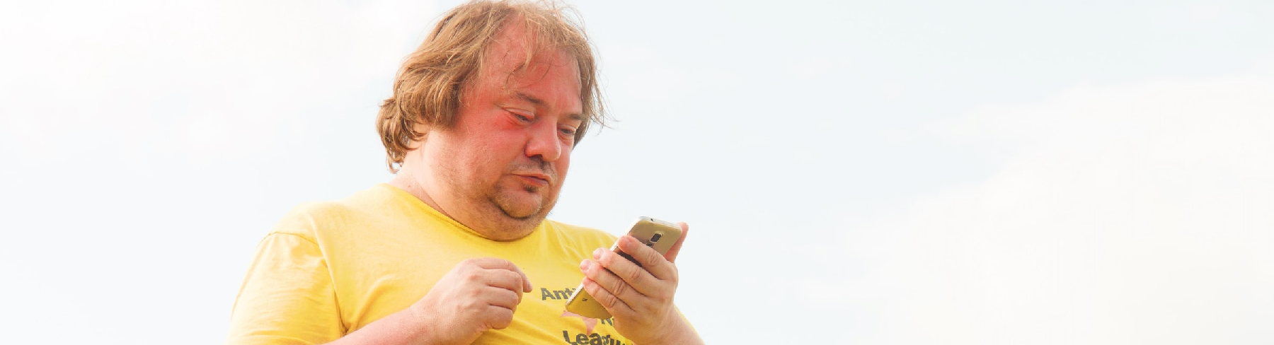 Obese man looking at phone