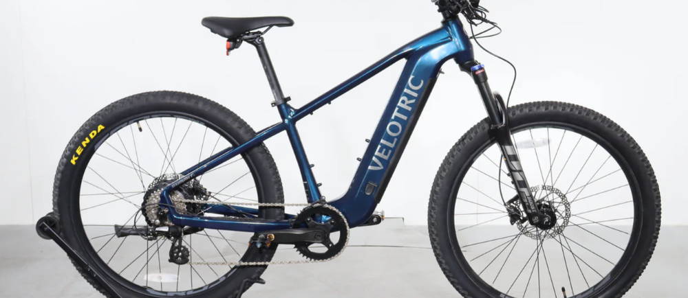 a blue Velotric Summit 1 front suspension electric mountain bike