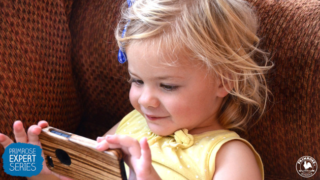 Little girl excitedly watches something on a smartphone