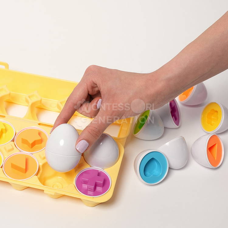 Woman's hand placing a white geometric egg into a yellow carton.