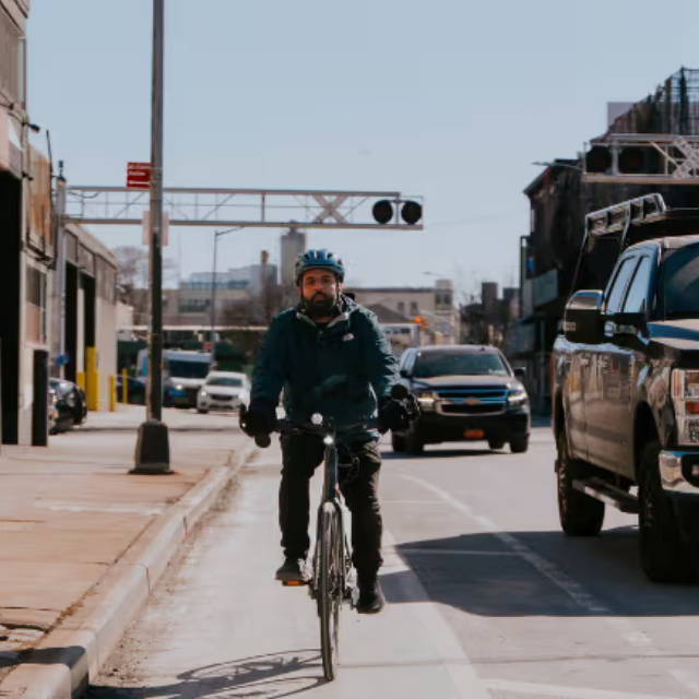 A man riding in a city on an e-Bike