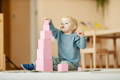 Toddler stacking wooden blocks. 