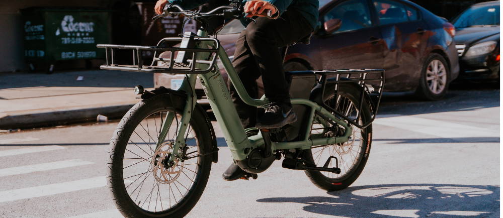 Momentum PAkYak+ electric cargo bike on sidewalk