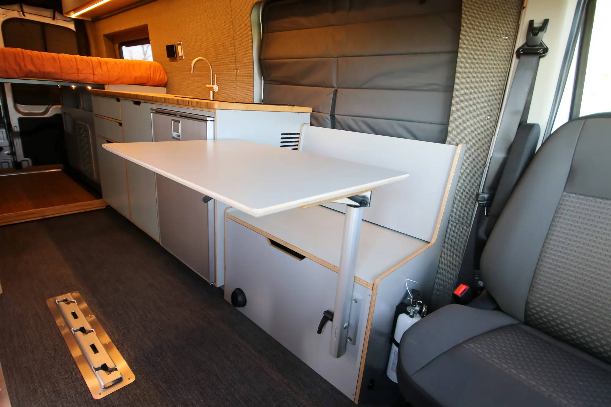 Adjustable Kitchen Table in Ford Transit Camper Conversion Van by The Vansmith