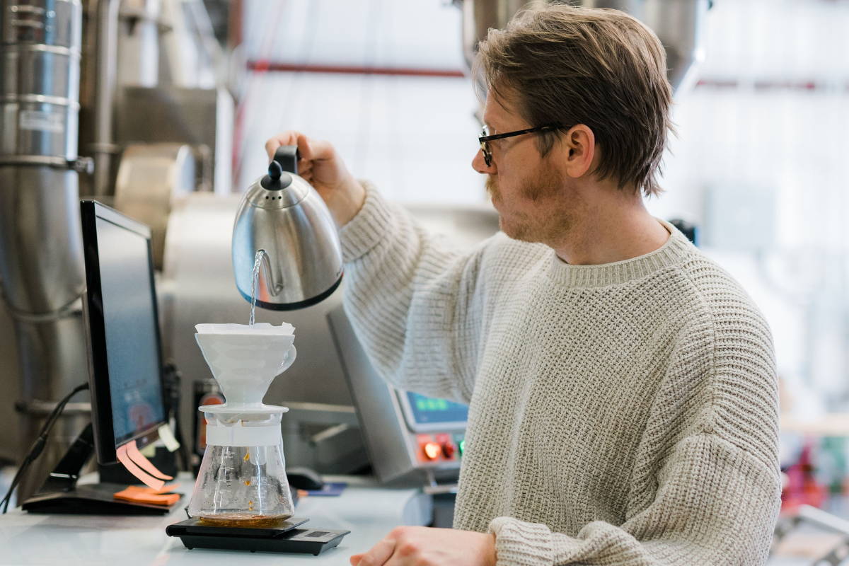 Coffee roaster making V60 pour over