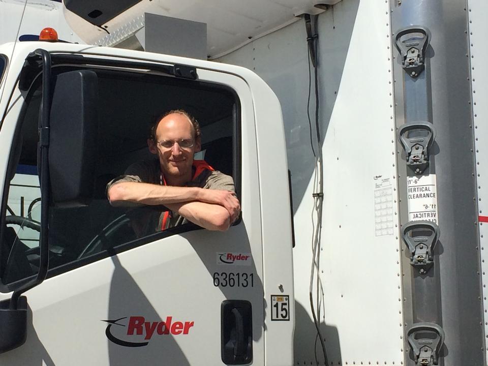Alex Bayer picking up product, driving the delivery truck