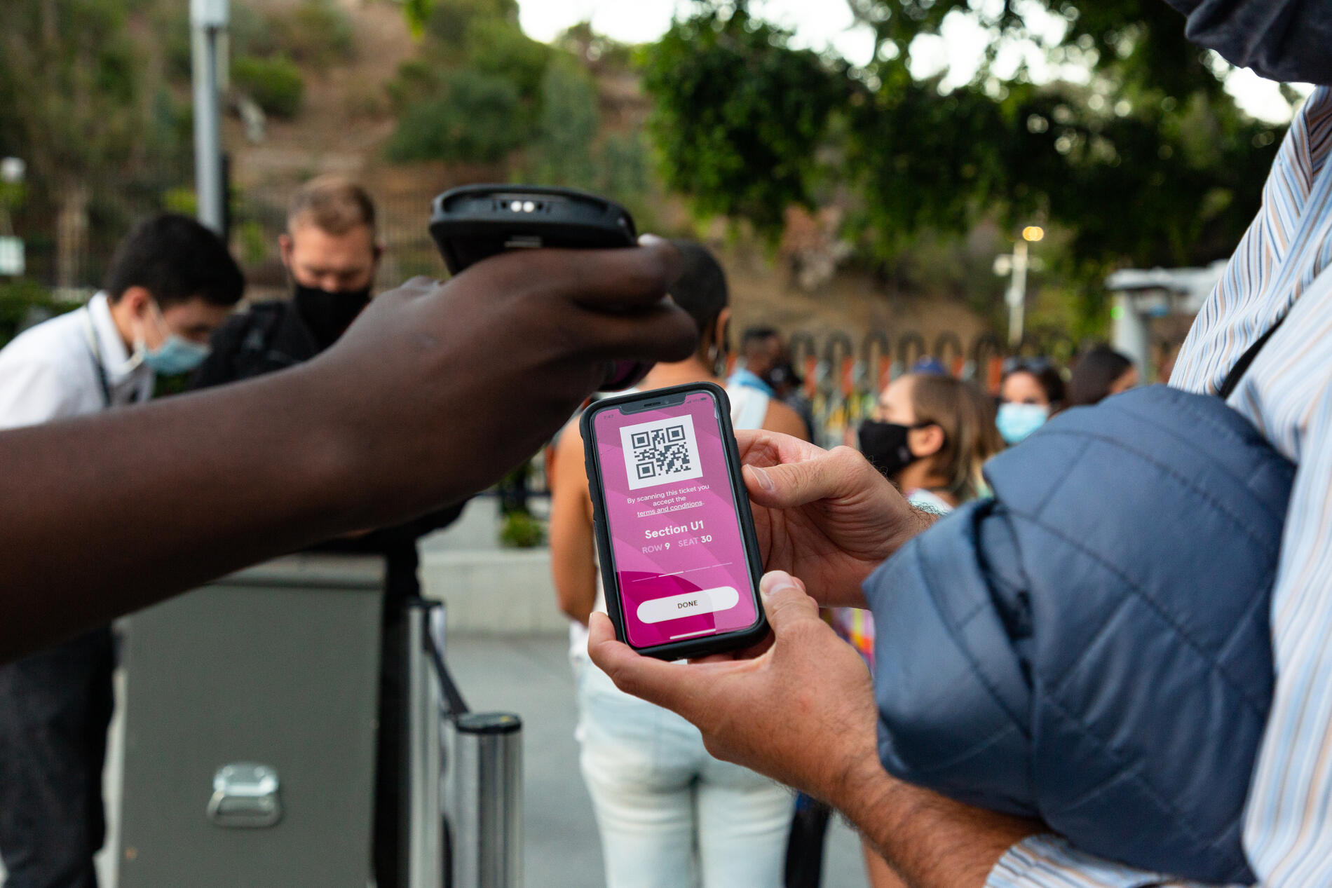 Audience member being scanned in at the gates with their digital ticket via the Hollywood Bowl app. 