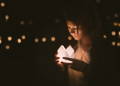 girl holding candle votive for memorial