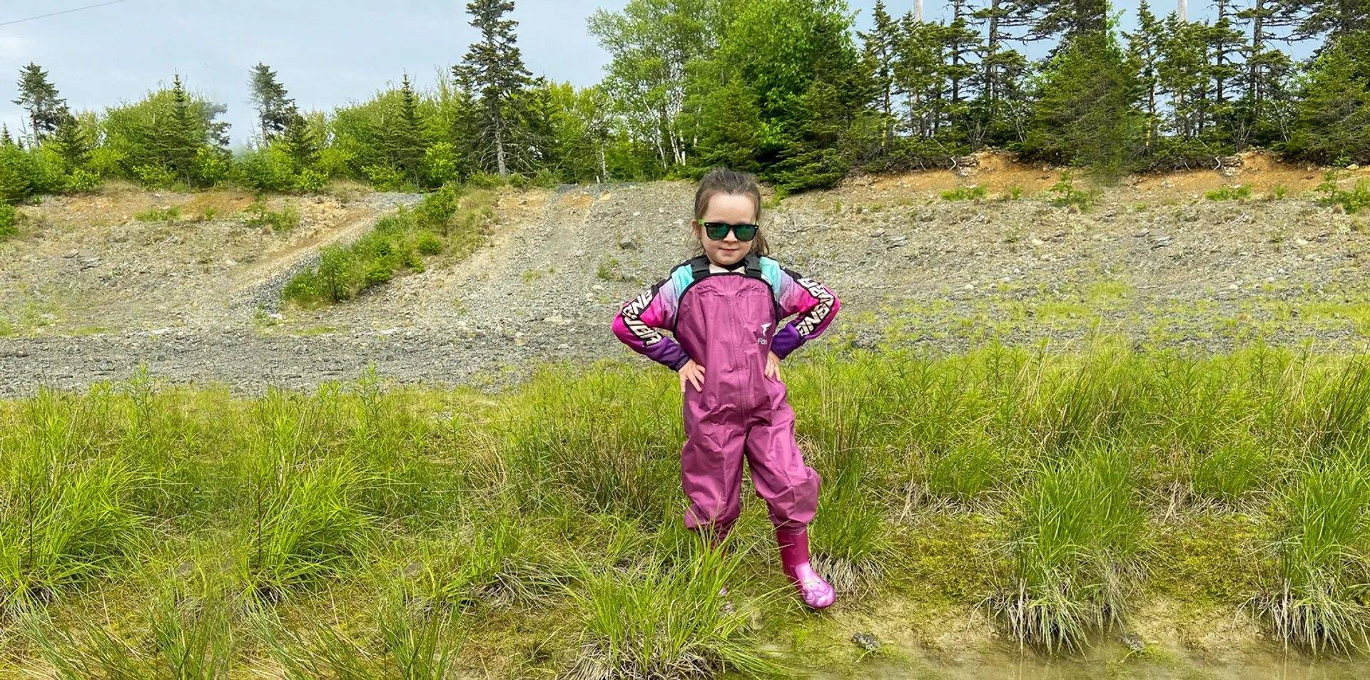 This kid wears the waterproof fishing chest waders to keep dry and cozy in her adventure