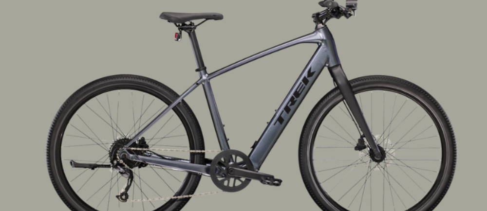 a silver Treck Dual Sport+ 2 electric commuter bike