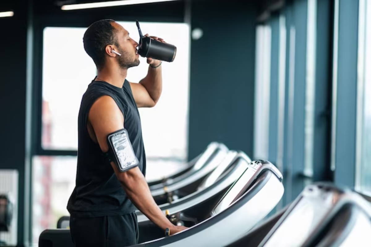 man drinking water on treadmill man drinking water on treadmill