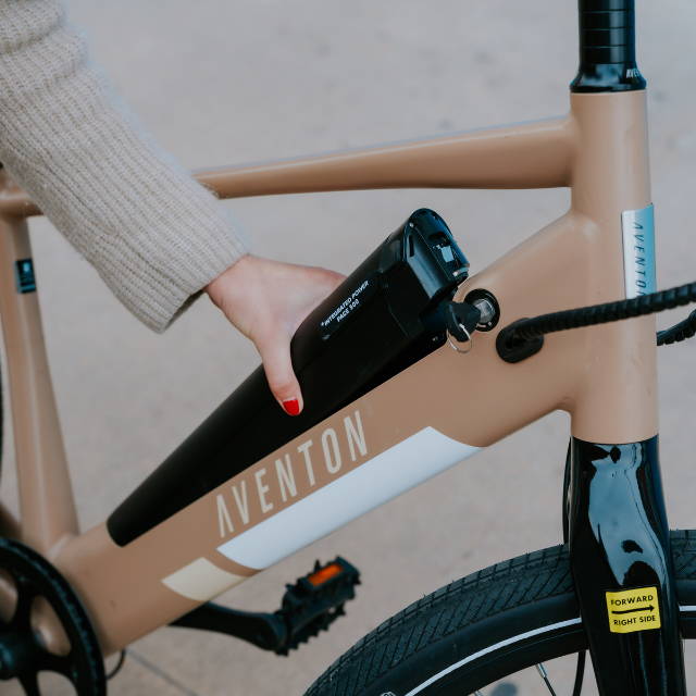 An e-Bike battery being removed from an Aventon bike