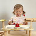 Little girl playing on a wooden Montessori Percussion Set.