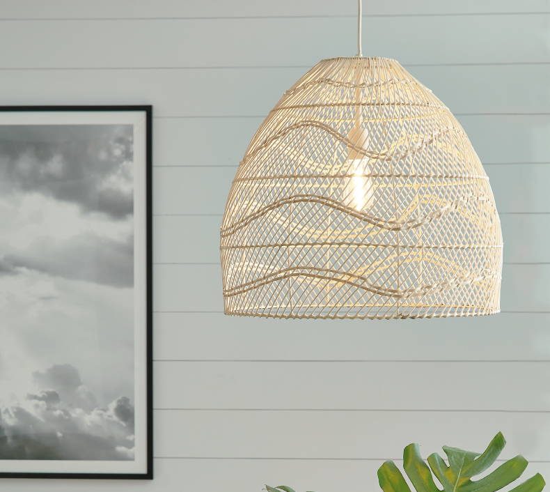 Pendant light adorned with a mesh cover in a light color. Click the "Shop Lighting" button to be directed to our in-stock lighting collection.