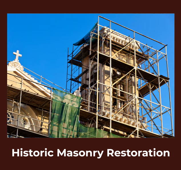 Historic stone church or cathedral under restoration, surrounded by scaffolding against a clear blue sky.
