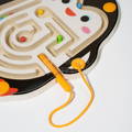 Close up showing multicolor balls moving through the wooden Montessori maze.