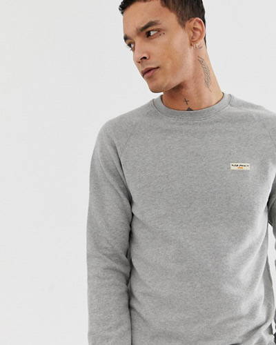 Man wearing grey organic cotton nudie jeans sweatshirt