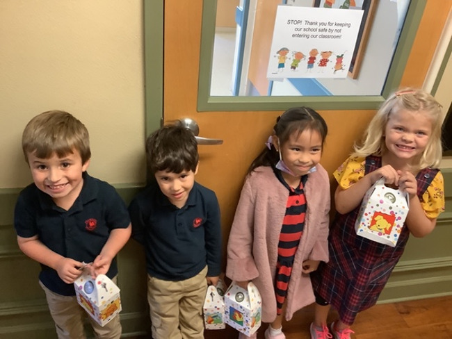 Photo of Primrose Kindergarteners posing with food donations