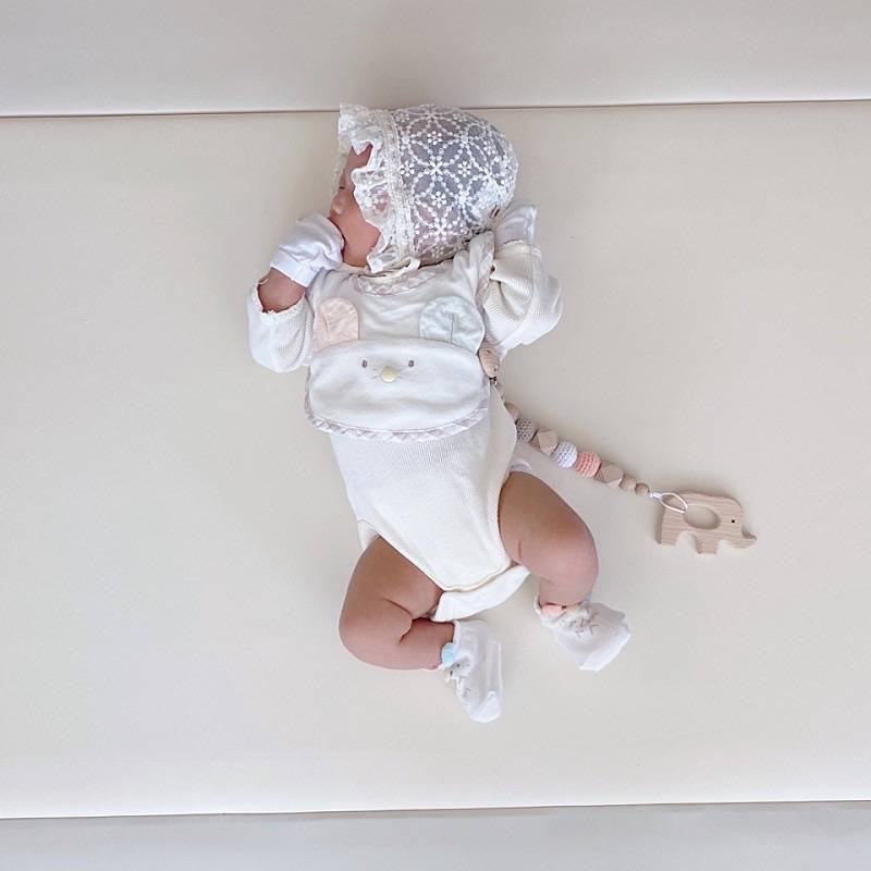 Newborn baby laying on AlZiP mat