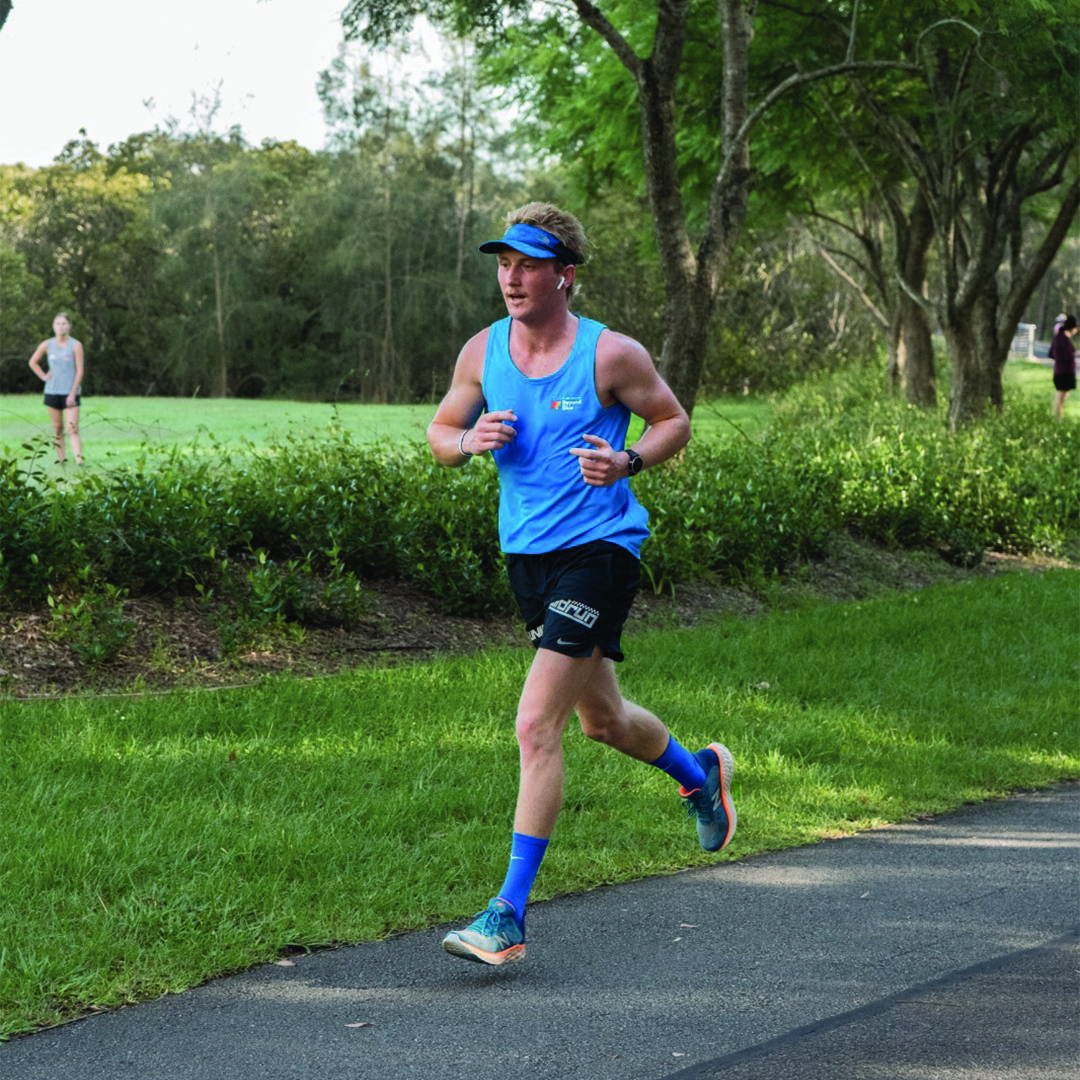 Male runner jogging along a path