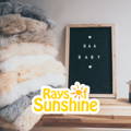 Sheepskin rugs and liners piled up next tp a board that says Baa Baby. The 'Rays of Sunshine' logo is superimposed on the image