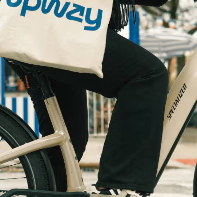 a woman riding a specialized Turbo Vado electric city bike in new york city