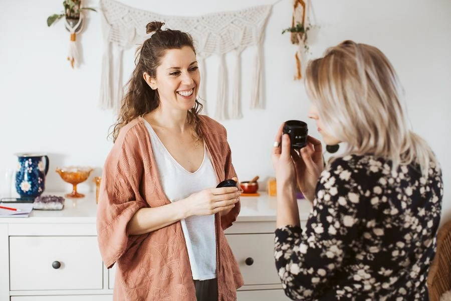 Two women smiling with AMLY products