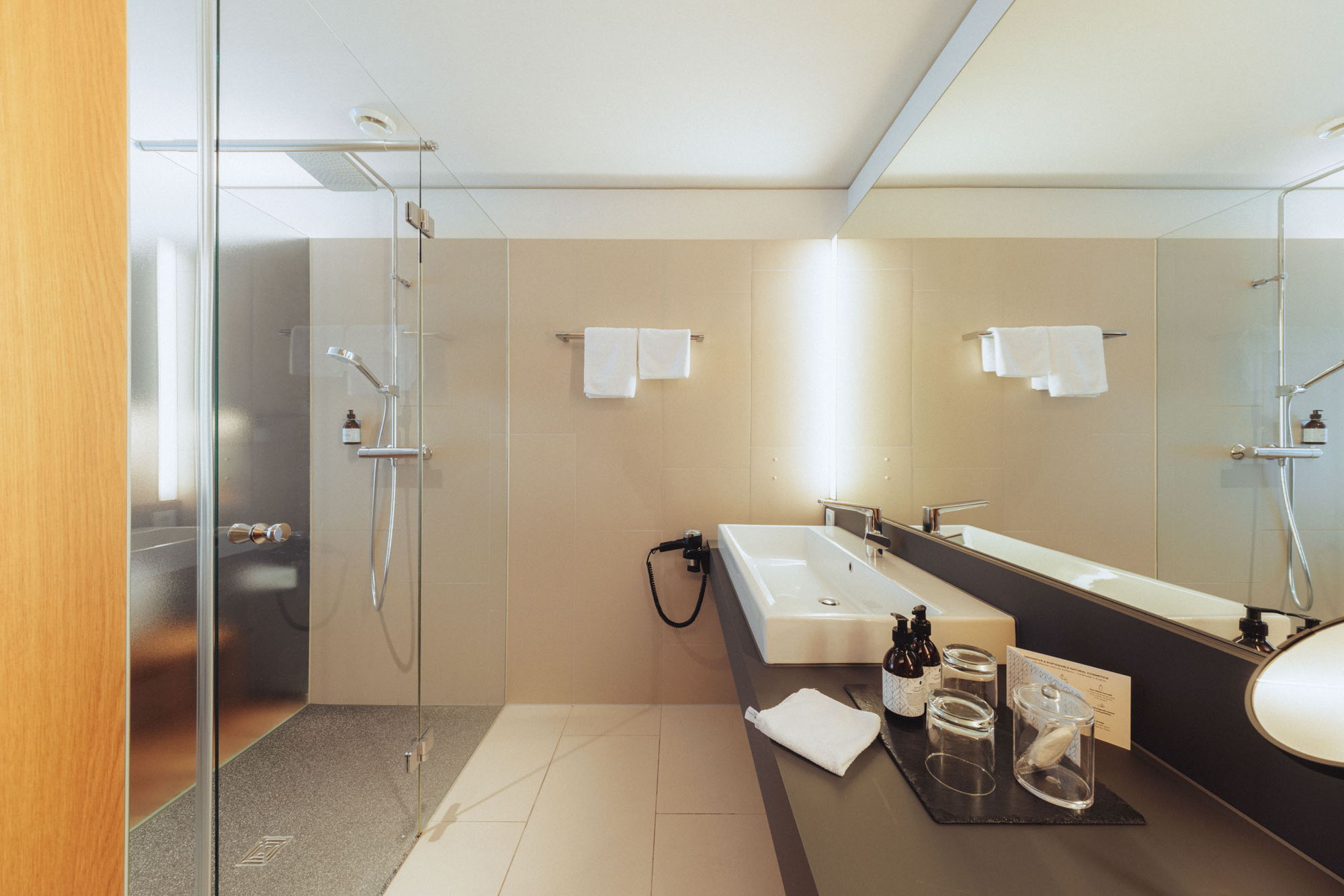 Modernes Badezimmer im Zimmer Hangspitze mit Dusche und Waschtisch