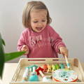 Little girl playing with her Montessori Music Set.