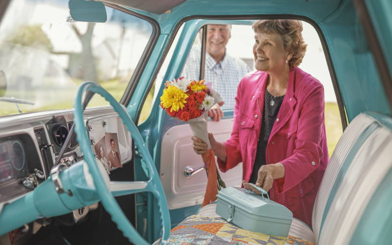 a photo of jenny getting into a truck with her quilting tools toolbox.