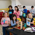 group of kids showing their cardboard models
