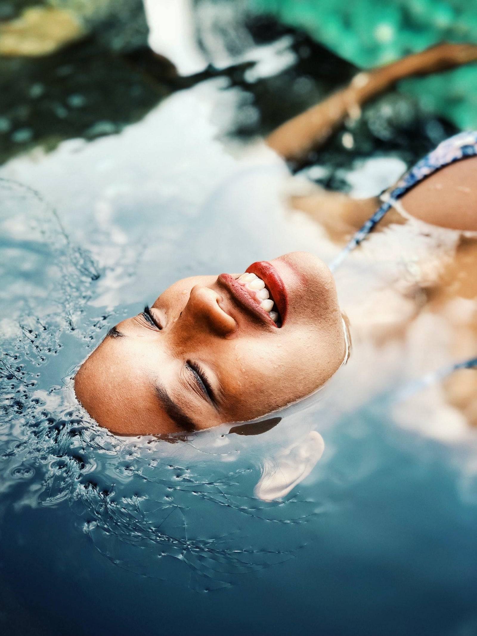 Woman laying face up in water