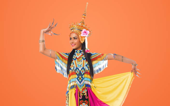A South Asian dancer wearing a traditional headdress and outfit for Confetti's Virtual Asian Dance Classes