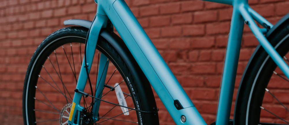 a light blue Tenways elctric city bike