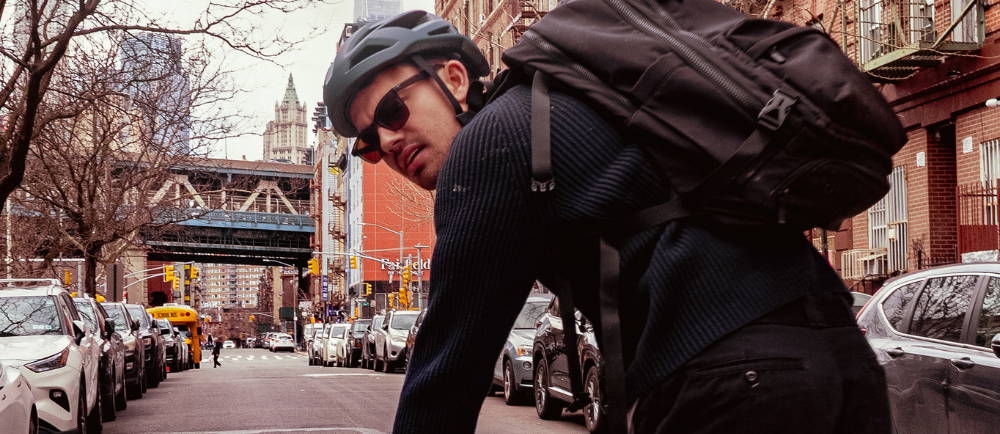 Male riding an ebike through a city