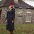 Ladies navy long coat worn with country attire after machine washing.