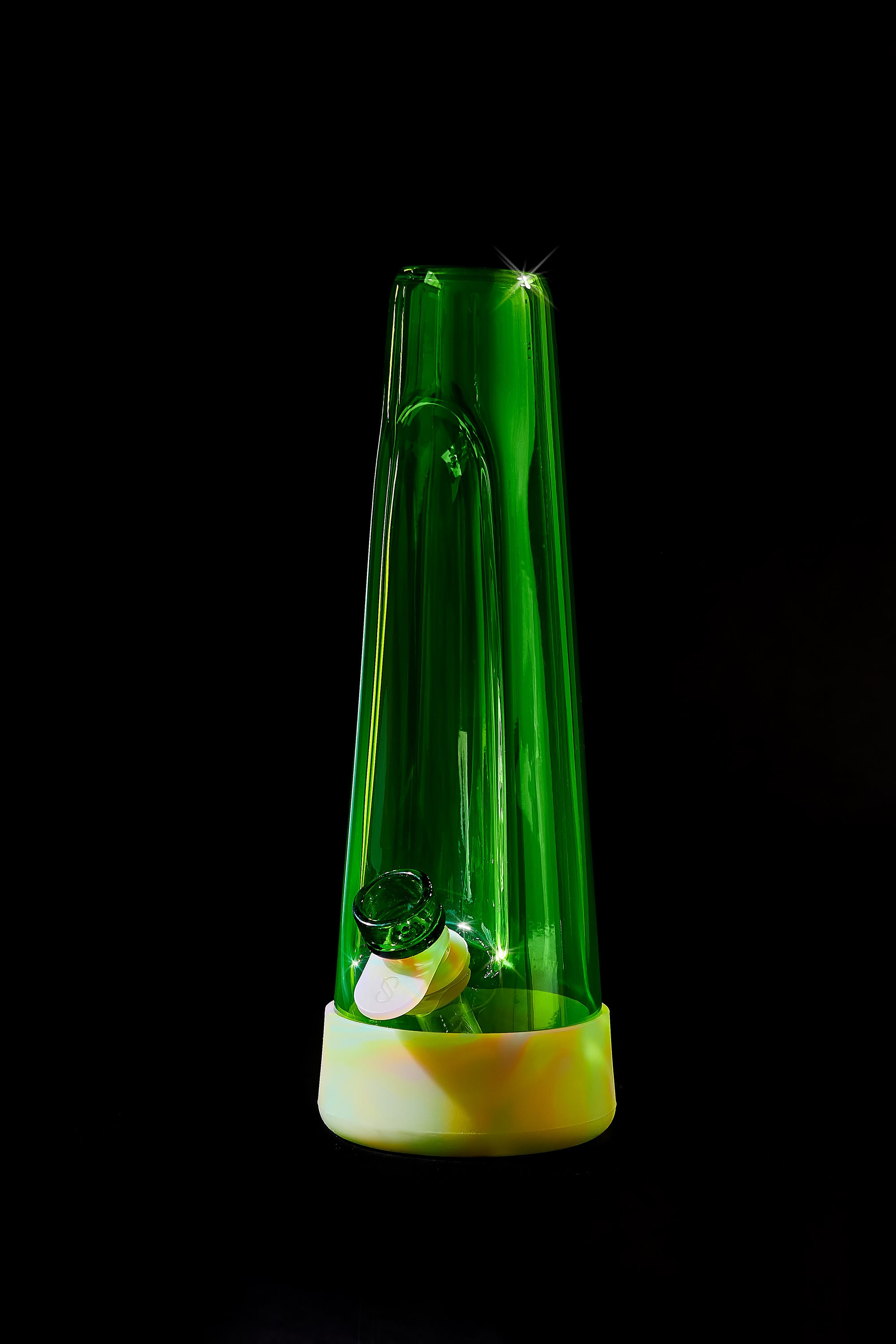 a green glass, glow-in-the-dark glass bong by session goods on a black background