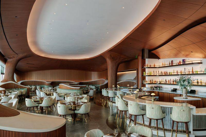 Image may contain: Indoors, Restaurant, Architecture, Building, Furniture, Lounge, Dining Table, Table, and Chair