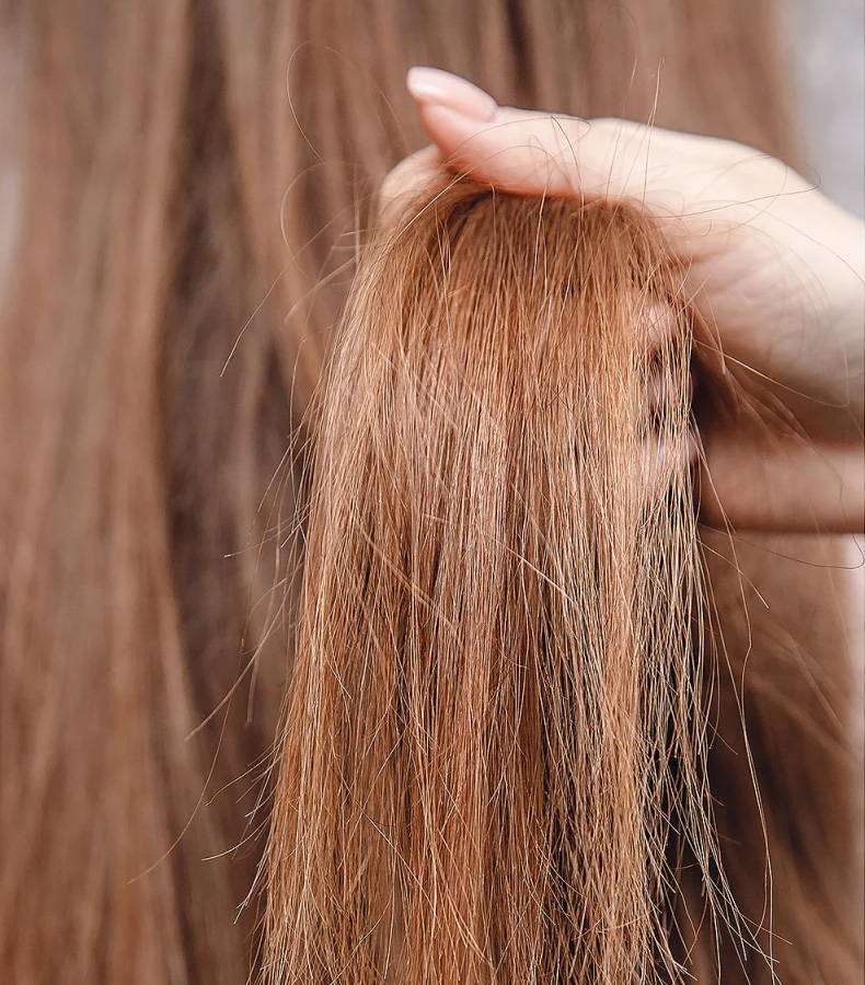 before and after image. this is the before image of wavy, frizzy red hair