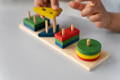 Close up of a toddler playing with wooden Montessori Building Blocks. 