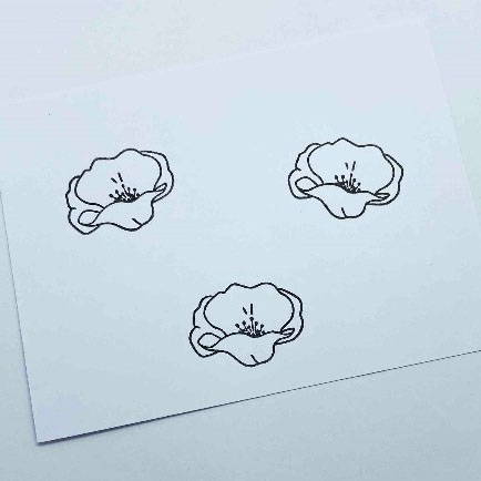 Three poppies stamped on white card using Tonic Studios Hybrid ink in Black Shadow