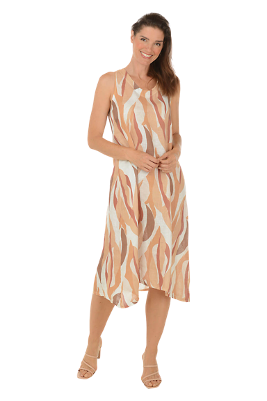 A woman wears a natural waves linen tie back dress.