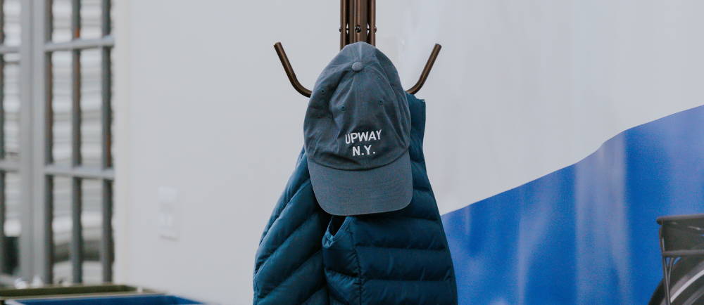 an upway ball cap on a hat rack at an upway center