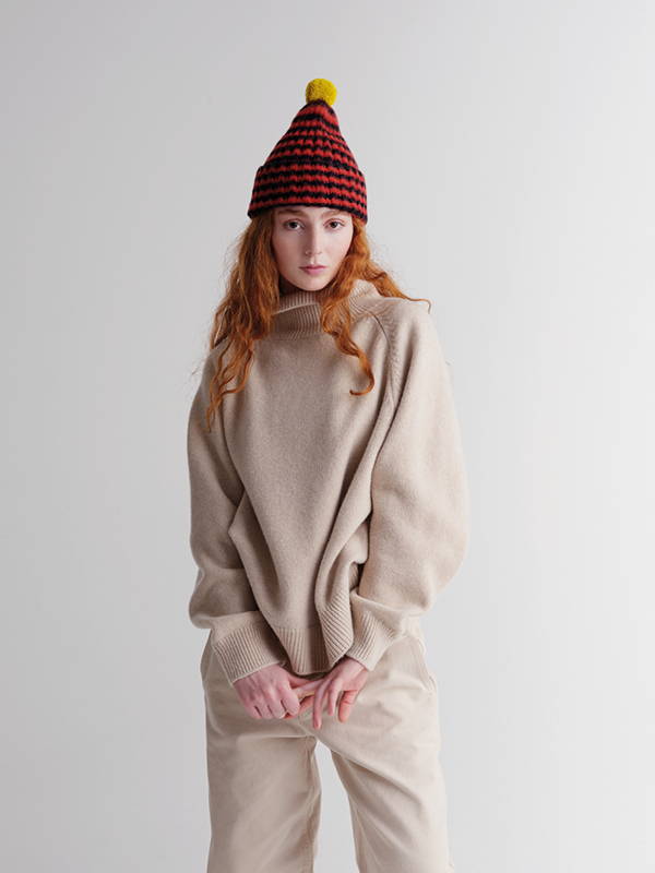 model wears Brushed Narrow Stripe Hat With Contrast Pompom Black & Red Dulse
