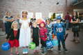 Children dressed up in costumes for Halloween.