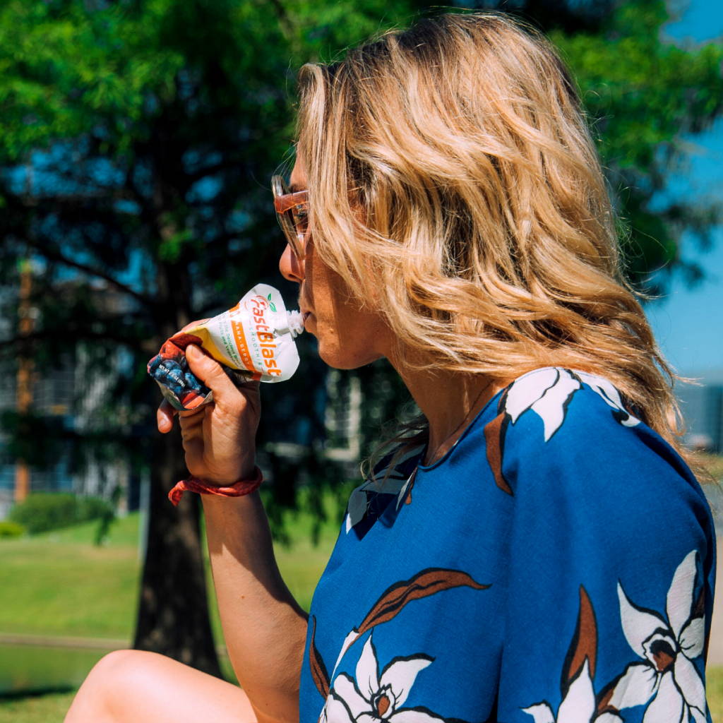Women in park drinking fast blast smoothie
