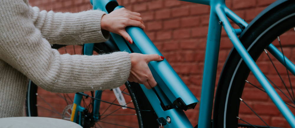 Rider removing the battery of Tenways electric bike