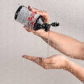 hands pouring Davines' ENERGIZING shampoo inside a shower